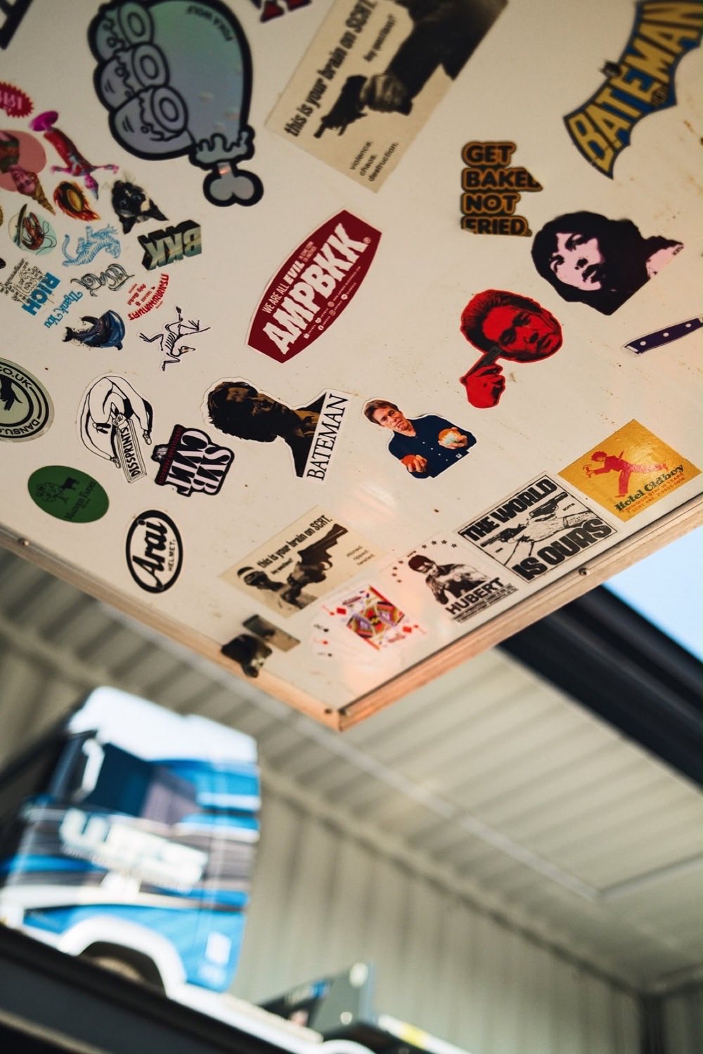 The ceiling inside the truck, covered in stickers collected from years of events.