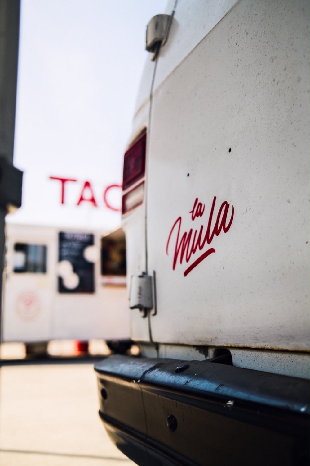 La Mula painted in red script on the back doors of the day van.