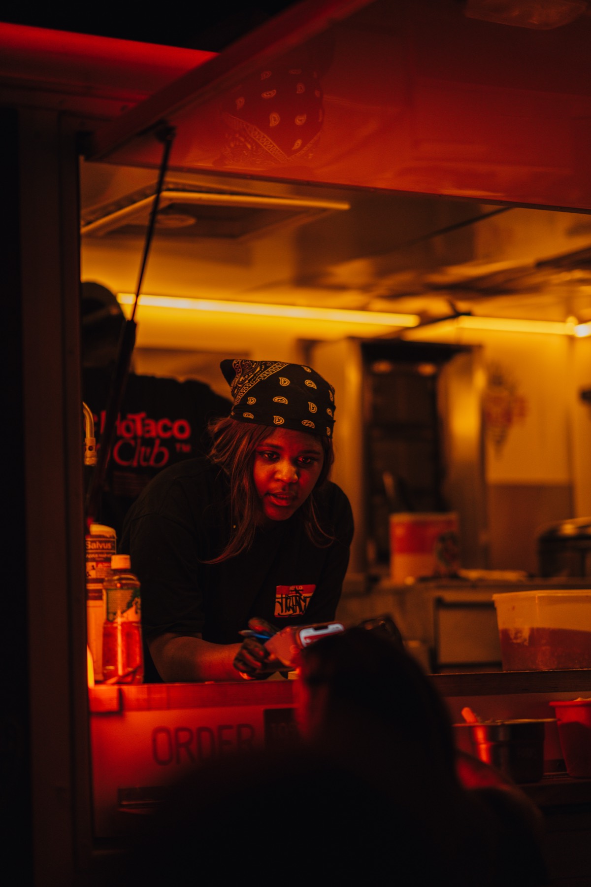 A member of the crew working the line inside the truck under warm light during service.